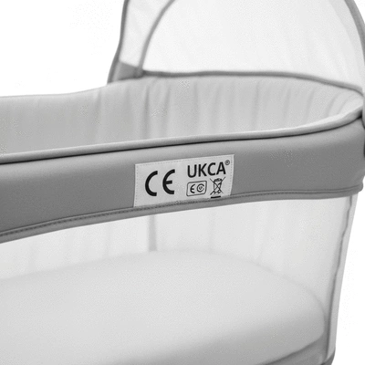 Close-up of a bassinet with a clear CE marking and UKCA marking on a label